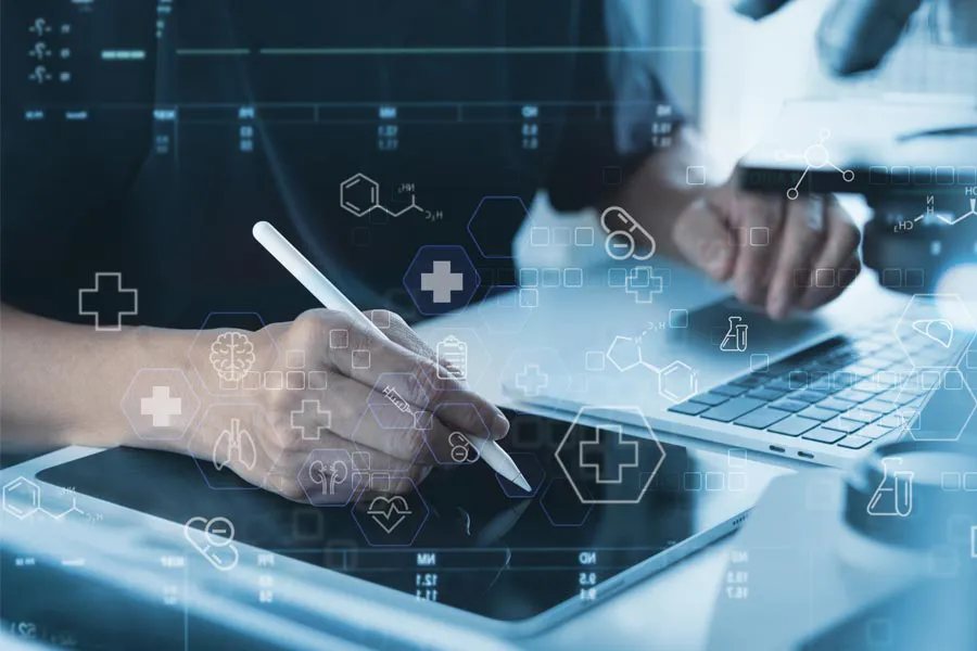 Health-Conditions-Treated-Doctor Close-up of a medical professional using a laptop and tablet, with illustrated medical symbols overlayed on the image, symbolizing health conditions treated by Discovery Health Healing Center in Green Bay.