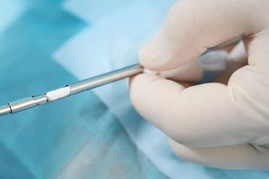 Hormone-Pellet-Therapy Close up of a doctor inserting a hormone pellet into a delivery device for hormone pellet treatments from Discovery Health Healing Center in Green Bay.