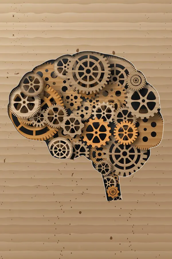 Neurodegenerative-Disorders-Treatment An illustration of a brain cut out of cardboard, with wooden cogs inside, representing neurodegenerative diseases treated by Discovery Health Healing Center in Green Bay.