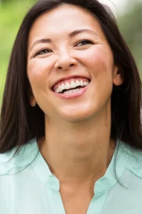ProdromeNEURO-for-Brain-Health-Treatment A laughing Asian woman. Get ProdromeNEURO for Brain Health from Discovery Health Healing Center in Green Bay.