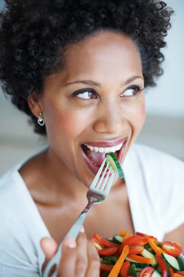 Weight-Loss-Treatment-2 A woman eats a healthy salad. Get Weight Loss treatment from Discovery Health Healing Center in Green Bay.